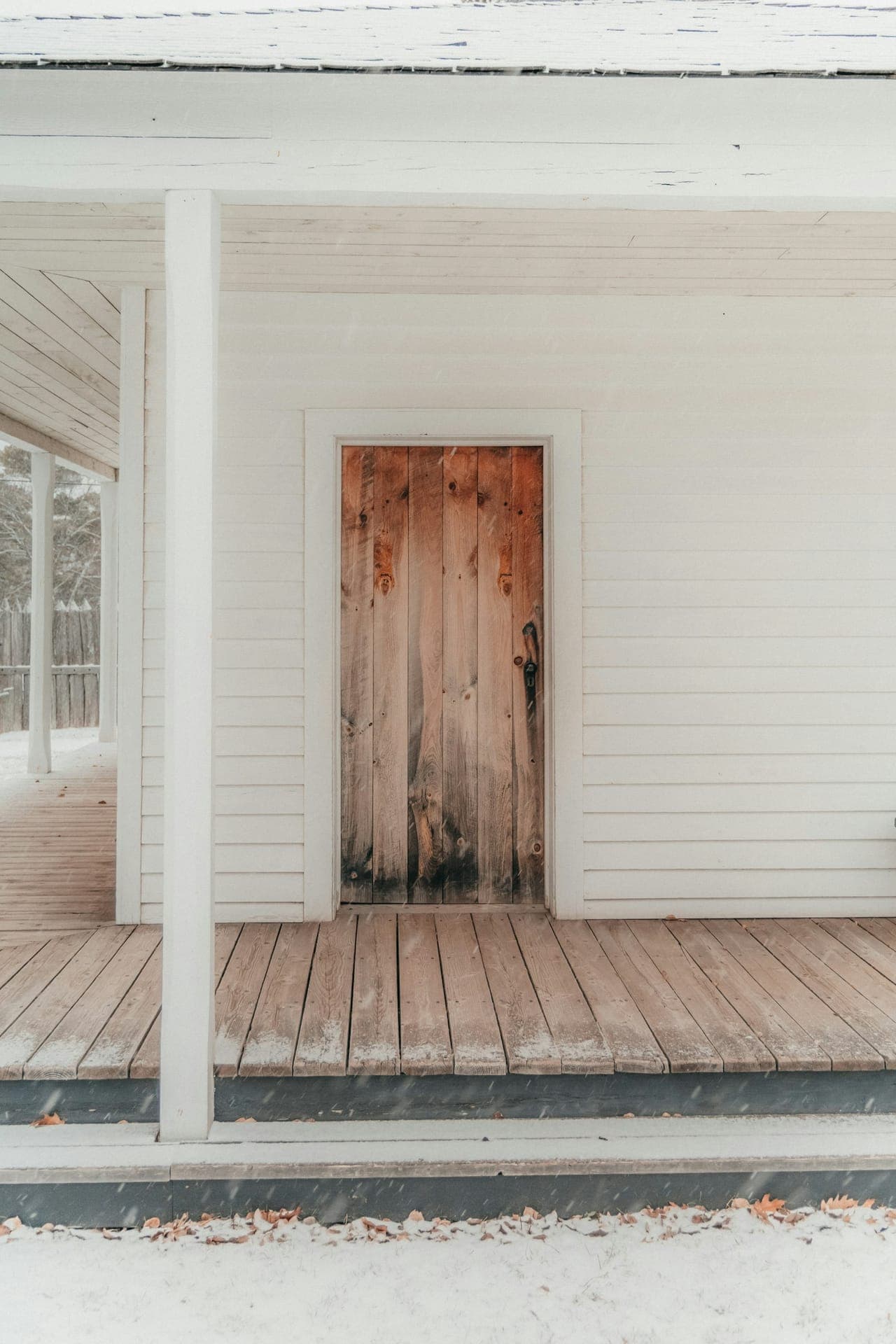 White exterior trim framing a door on a covered porch